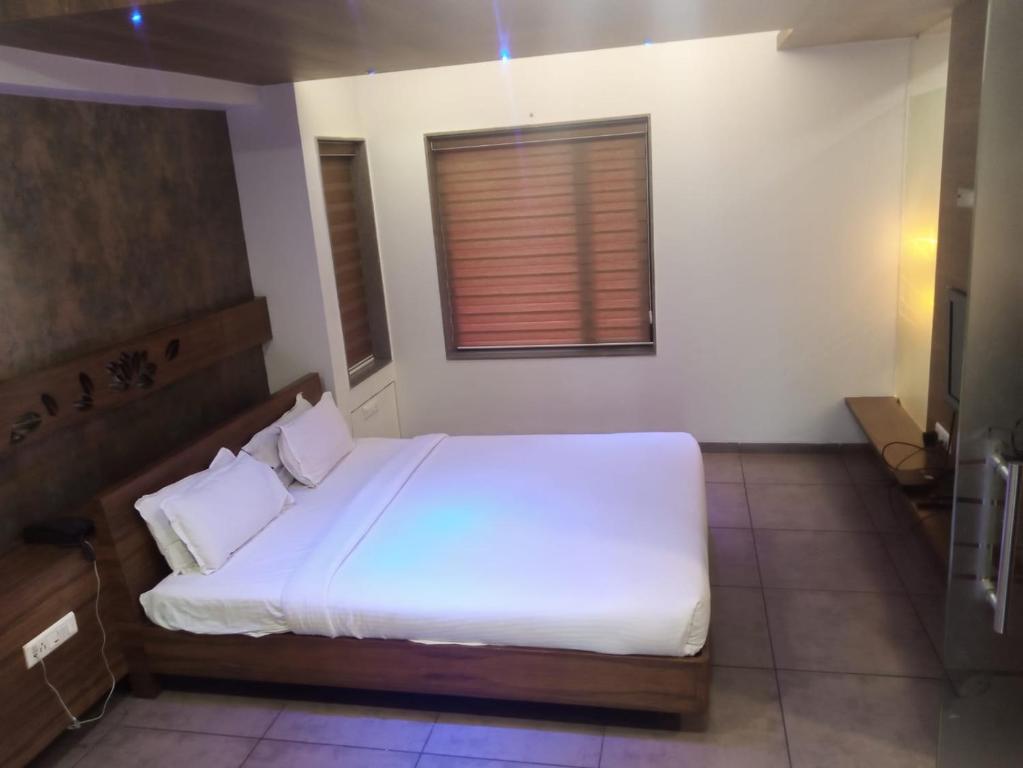 Postel nebo postele na pokoji v ubytování Hotel Kanan