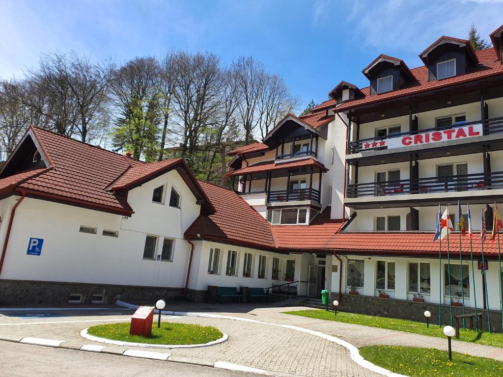 a large building with a red roof at Cristal Sinaia in Sinaia