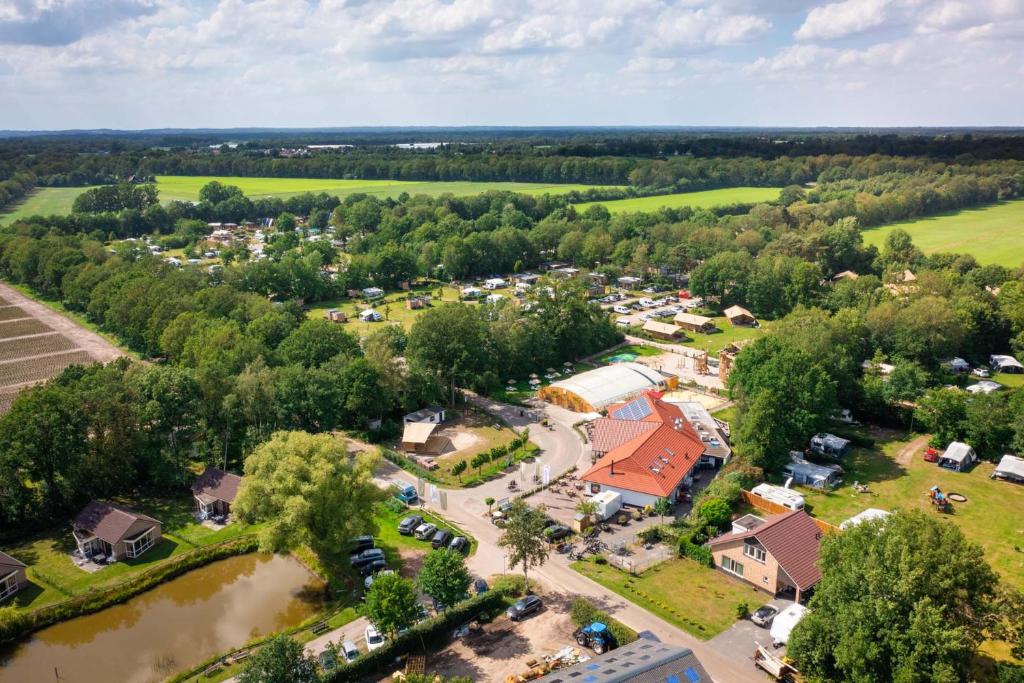 an aerial view of a small village with a river at Papillon Country Resort in Denekamp