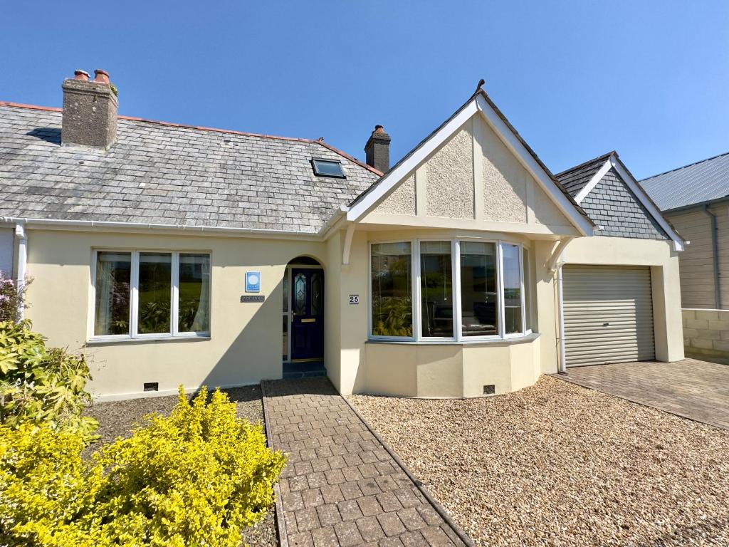a large white house with a garage at Pendennis in Padstow