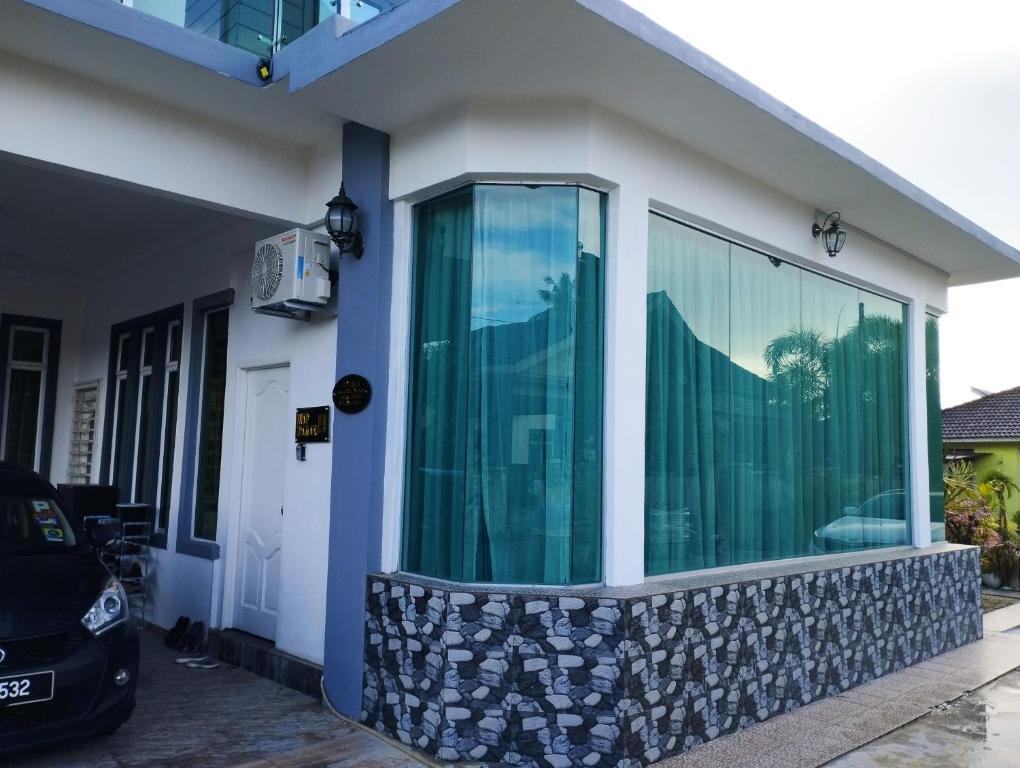 a house with a large glass window on it at Inap Idaman 4 Near Hospital HUSM Kubang Kerian in Kota Bharu