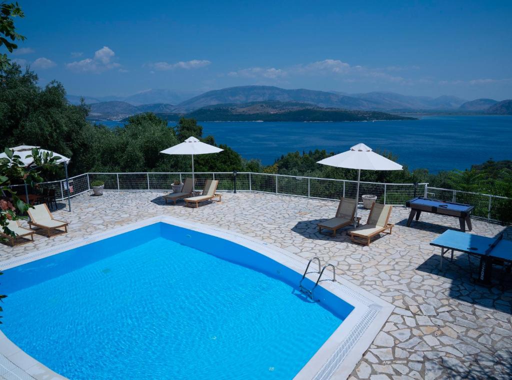 a swimming pool with a view of the water at Bellina Villa in Agnítsini