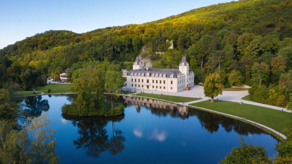 an aerial view of a castle on a lake at Hotel Schloss Hernstein in Hernstein