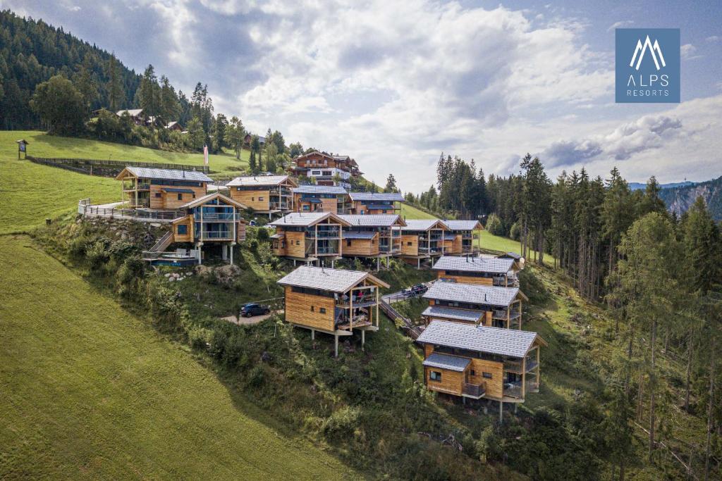 an aerial view of a group of houses on a hill at Alpenchalets Reiteralm by ALPS RESORTS in Schladming