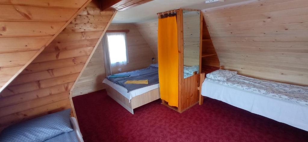widok na sypialnię w drewnianym domku w obiekcie Casa de vacanta - Vendeghaz w mieście Borsec