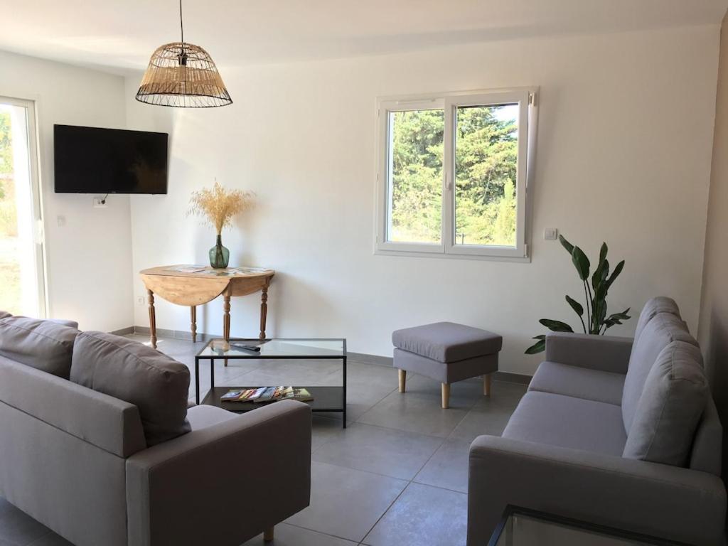 a living room with two couches and a tv at Gite la Garrigue in Ferrals-lès-Corbières