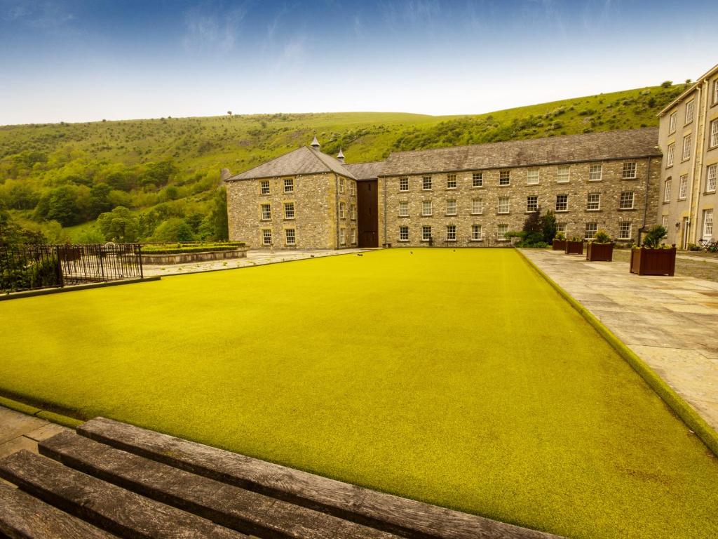 a large grass field in front of a building at The Mill in Buxton