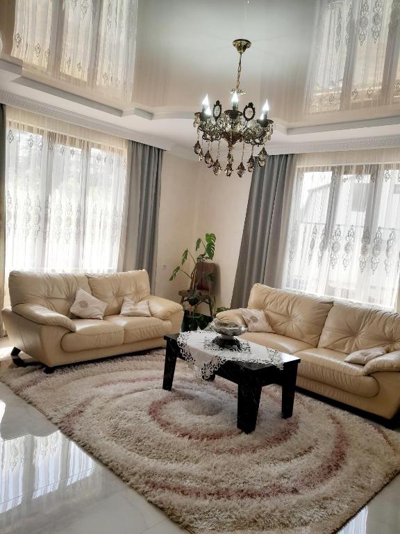 a living room with two couches and a table at Guest House Dimitri in Chakvi