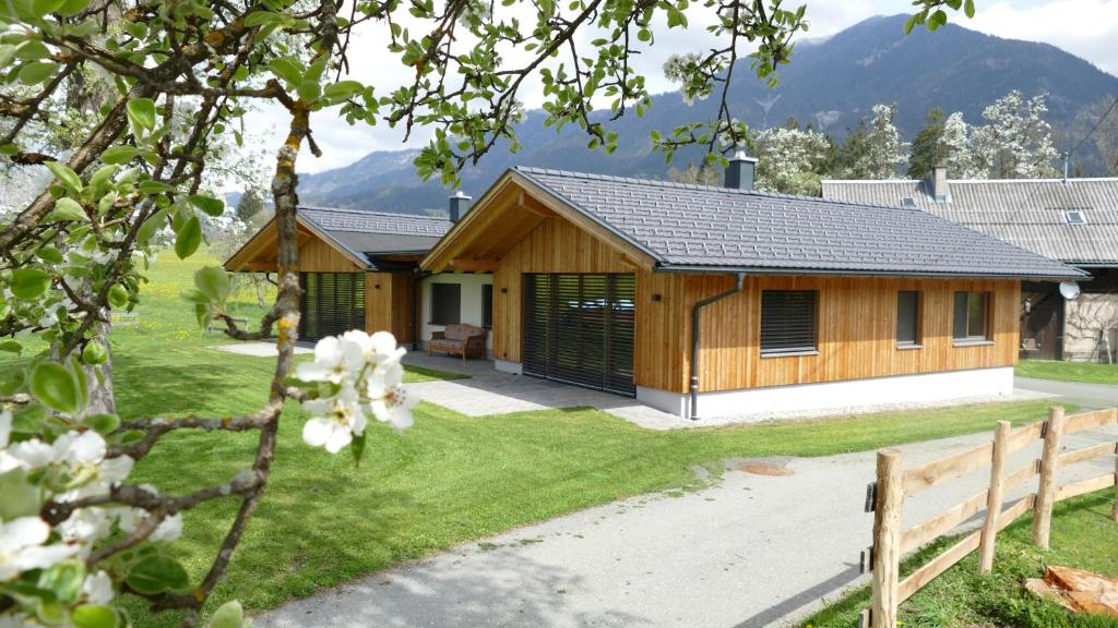 a wooden house with a fence in front of it at Ferienhaus Strohschneider in Hermagor