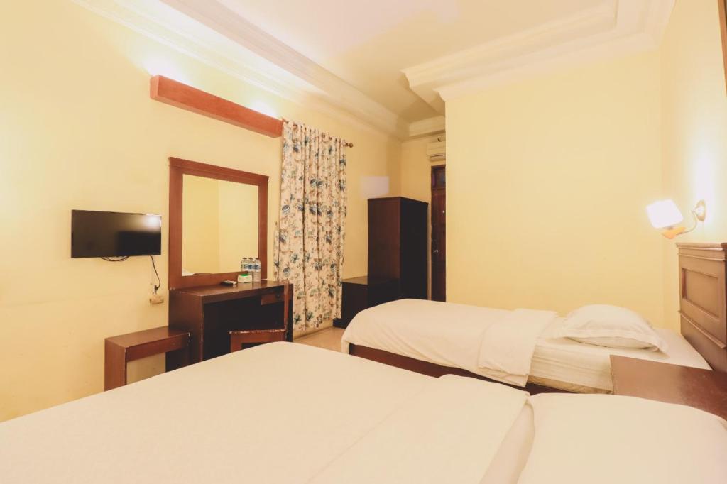 Postel nebo postele na pokoji v ubytování PIA Hotel Medan
