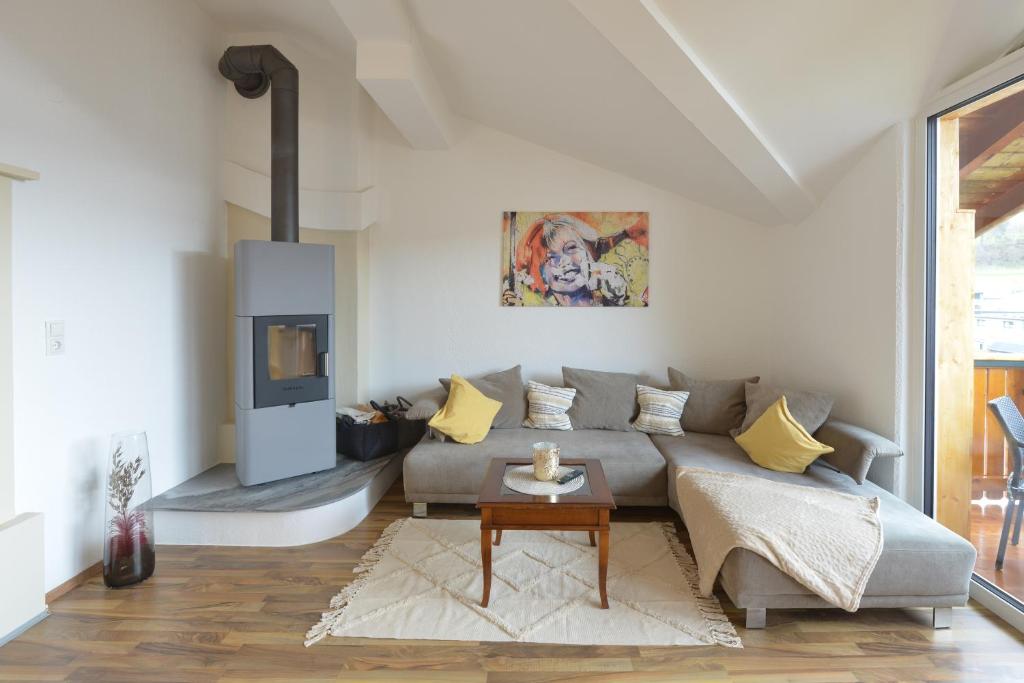 a living room with a couch and a fireplace at Klausner Kunterbunt in Volders