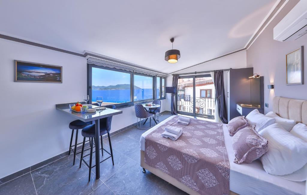 a living room with a bed and a table in a room at White House Apart in Kaş