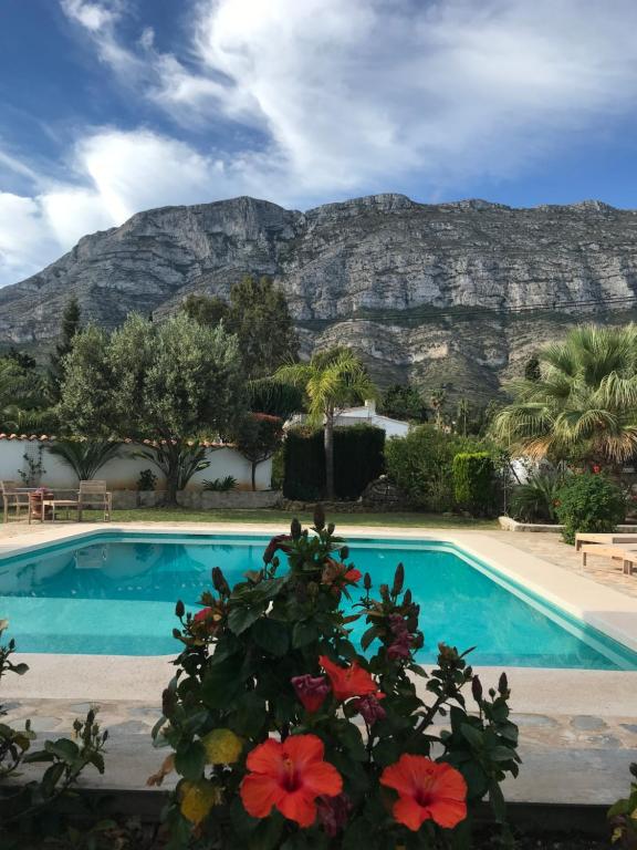 a pool with a mountain in the background at Casa Samsara Yaranda in Denia