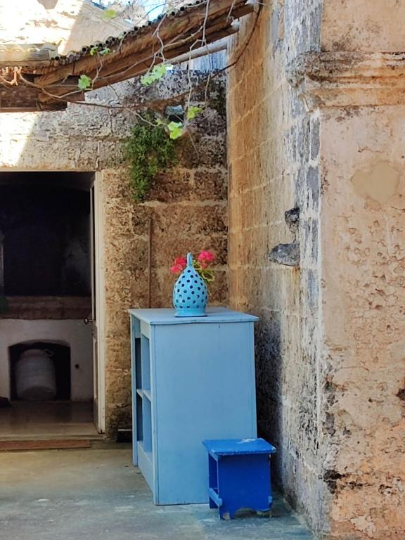 a blue cabinet with a vase sitting on top of it at La Fragna in Nardò