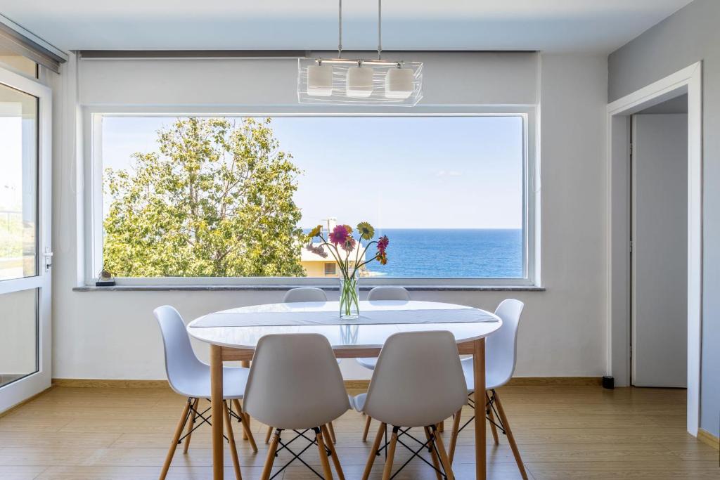 a dining room with a table and chairs and a large window at Stelianas House Ground Floor Apartment with Private Pool in Lygaria