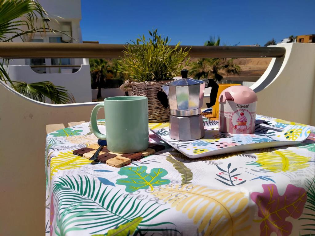 a table with a table cloth with a coffee maker on it at Casa Clara in Costa de Antigua