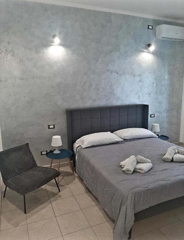 a bedroom with a bed and a chair and lights at La Nchioscia in La Spezia