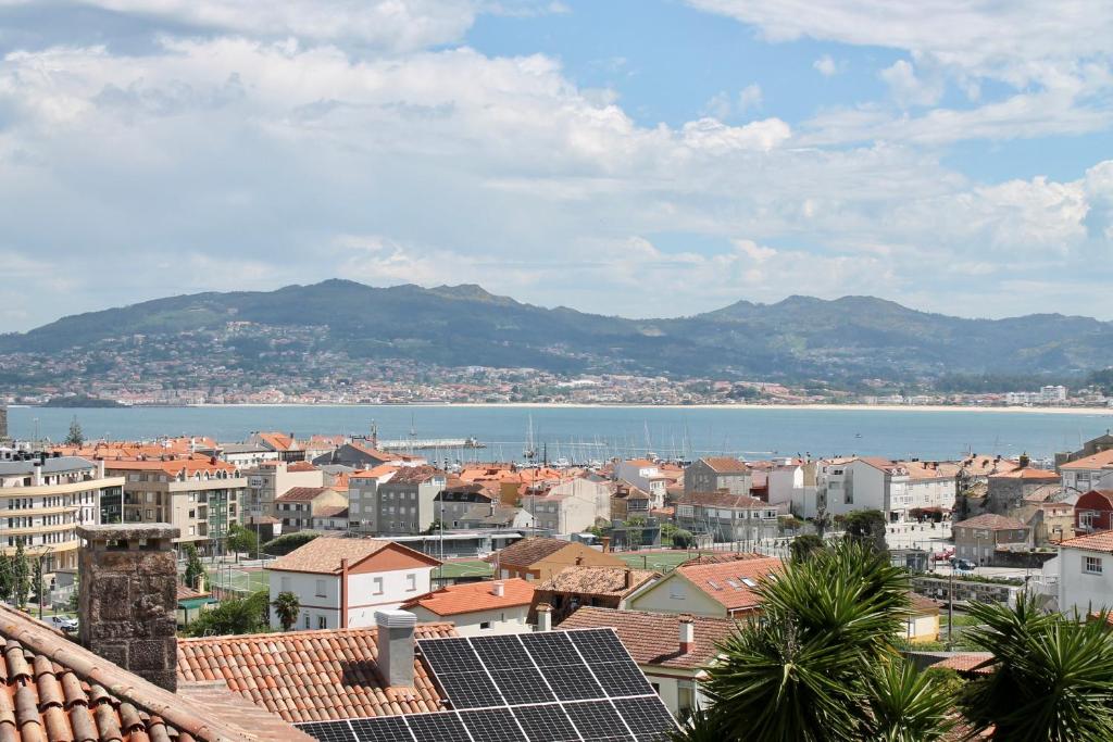 a city with a view of the water and buildings at Altos de Baiona in Baiona