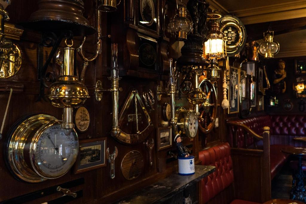 a room with a bunch of clocks on the wall at The Olde Ship Inn in Seahouses