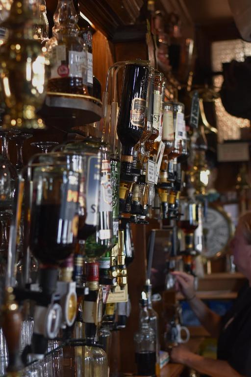 a bar with a lot of bottles of alcohol at The Olde Ship Inn in Seahouses