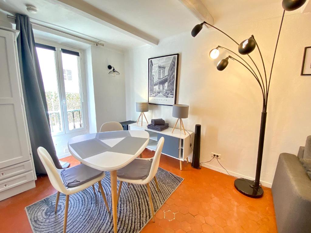 salon ze stołem, krzesłami i lampką w obiekcie La Castre By SCLS Locations w Cannes