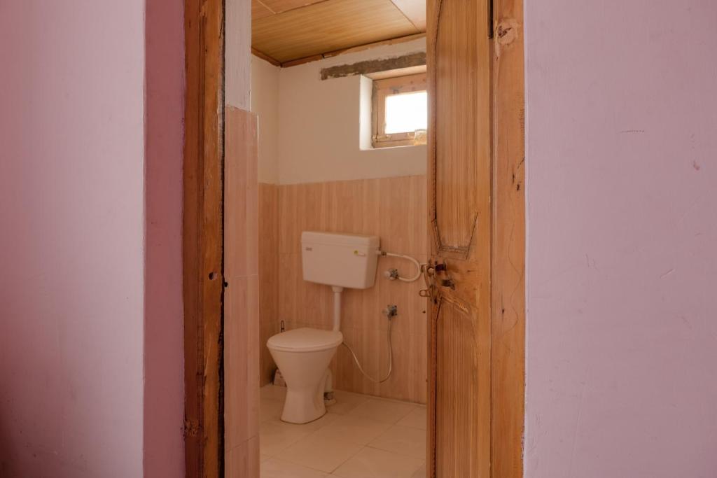 a small bathroom with a toilet and a window at Astrostays at Pangong in Spangmik