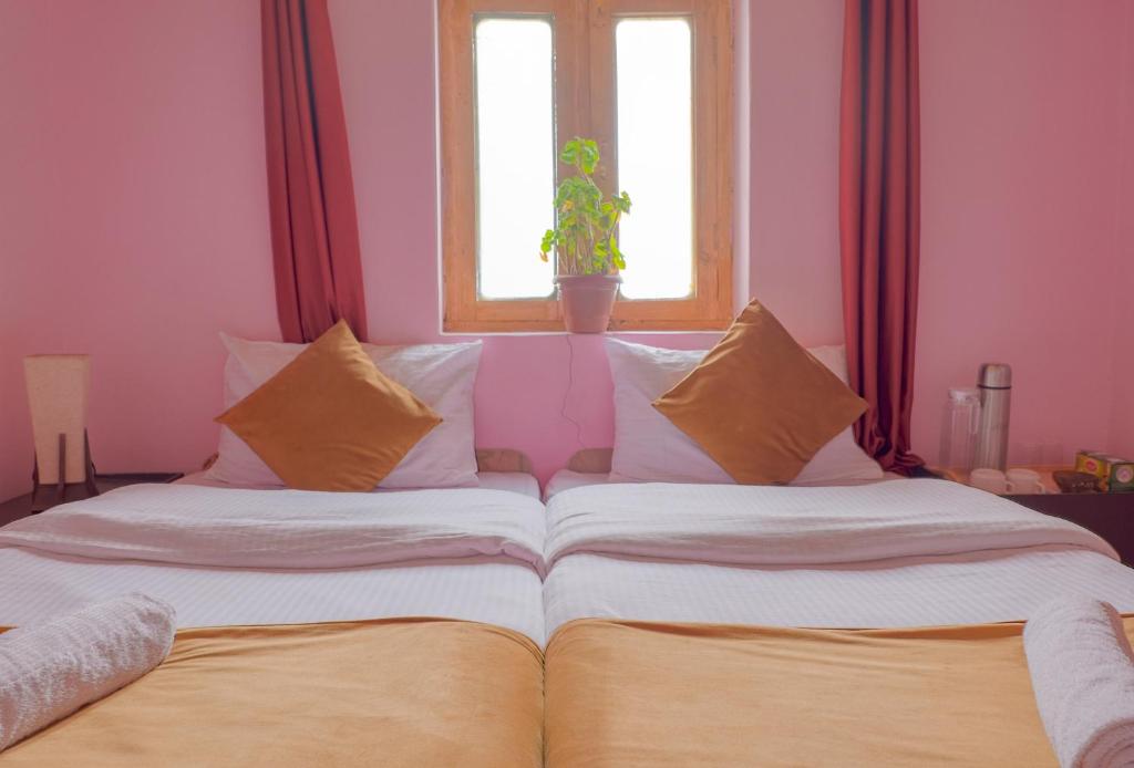 a large bed in a room with a window at Astrostays at Pangong in Spangmik