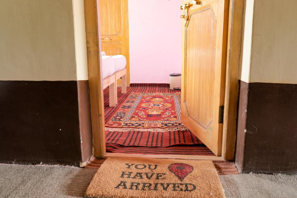 an open door with a sign that says you have arrived at Astrostays at Pangong in Spangmik