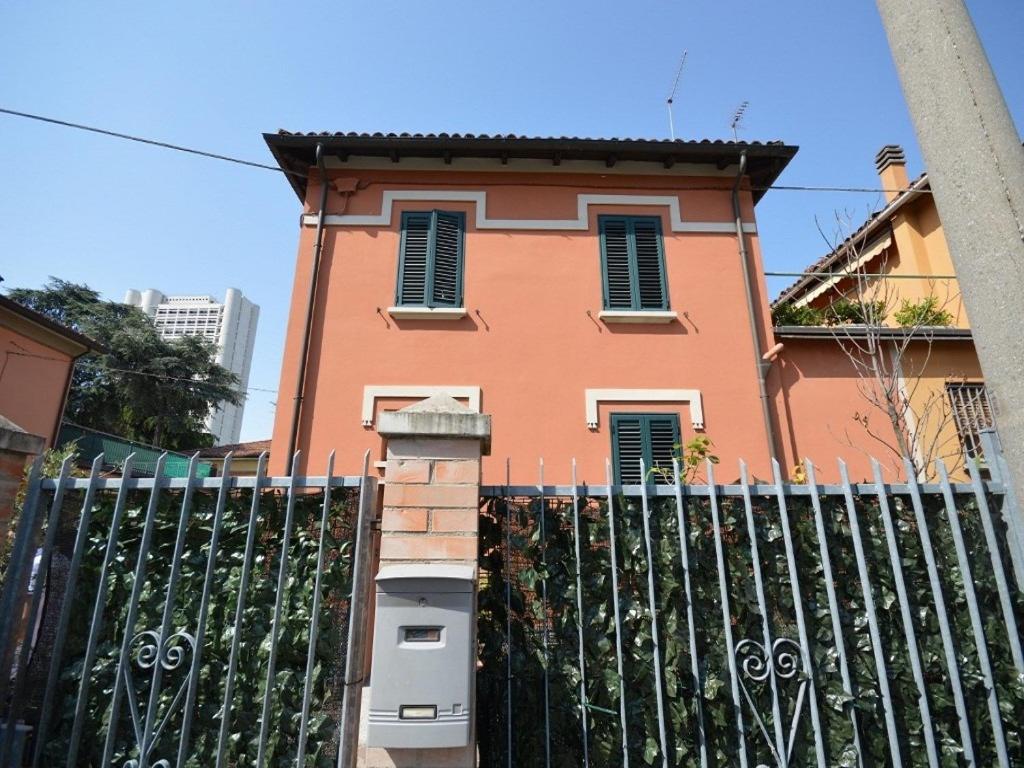 a pink building with a fence in front of it at Piana, Bologna by Short Holidays in Bologna