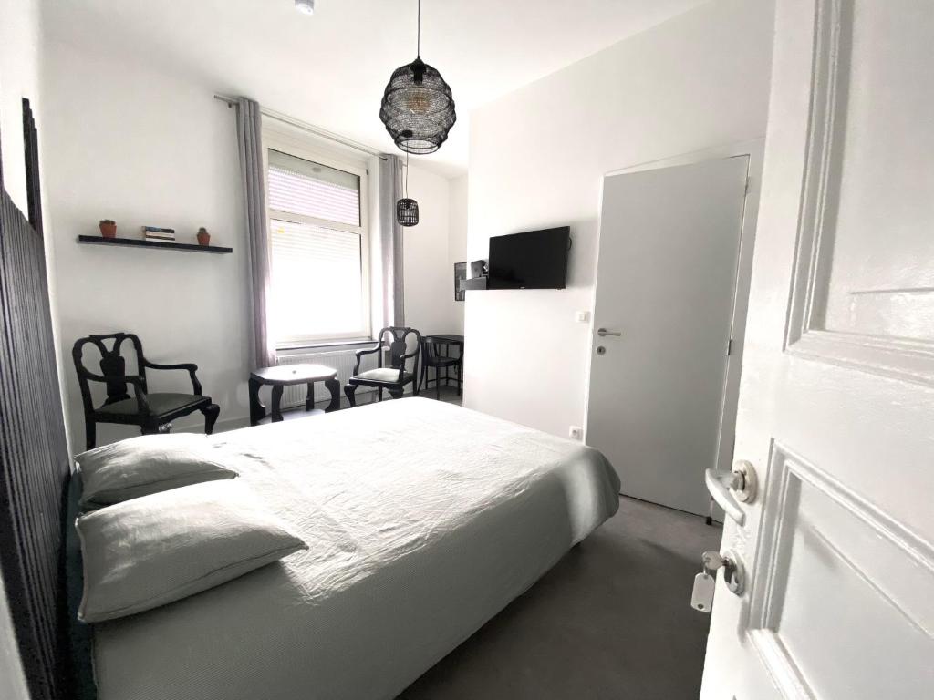 Postel nebo postele na pokoji v ubytování Au logement mosan