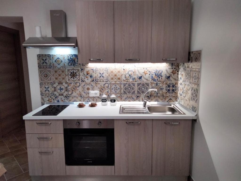 a small kitchen with a sink and a stove at LA TERRAZZA in Ioppolo Giancaxio