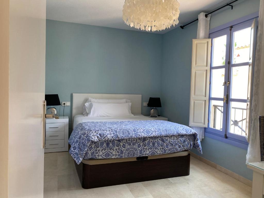 フィネストラットにあるApartamento Golf Bahia 37の青いベッドルーム(ベッド1台、シャンデリア付)