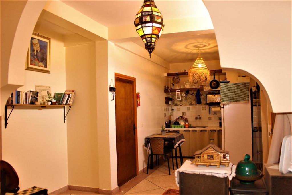 a room with a kitchen with a table and a refrigerator at Asunfou : Appartement d'apaisement in Mirleft