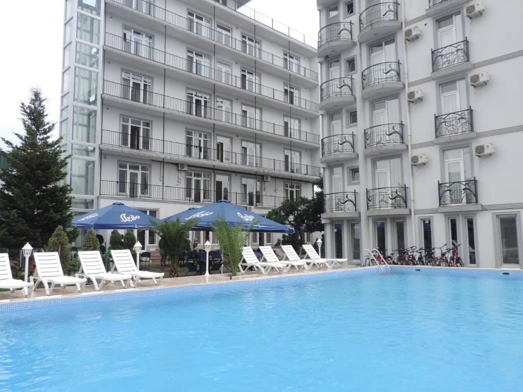 a large swimming pool in front of a building at Beach House in Batumi