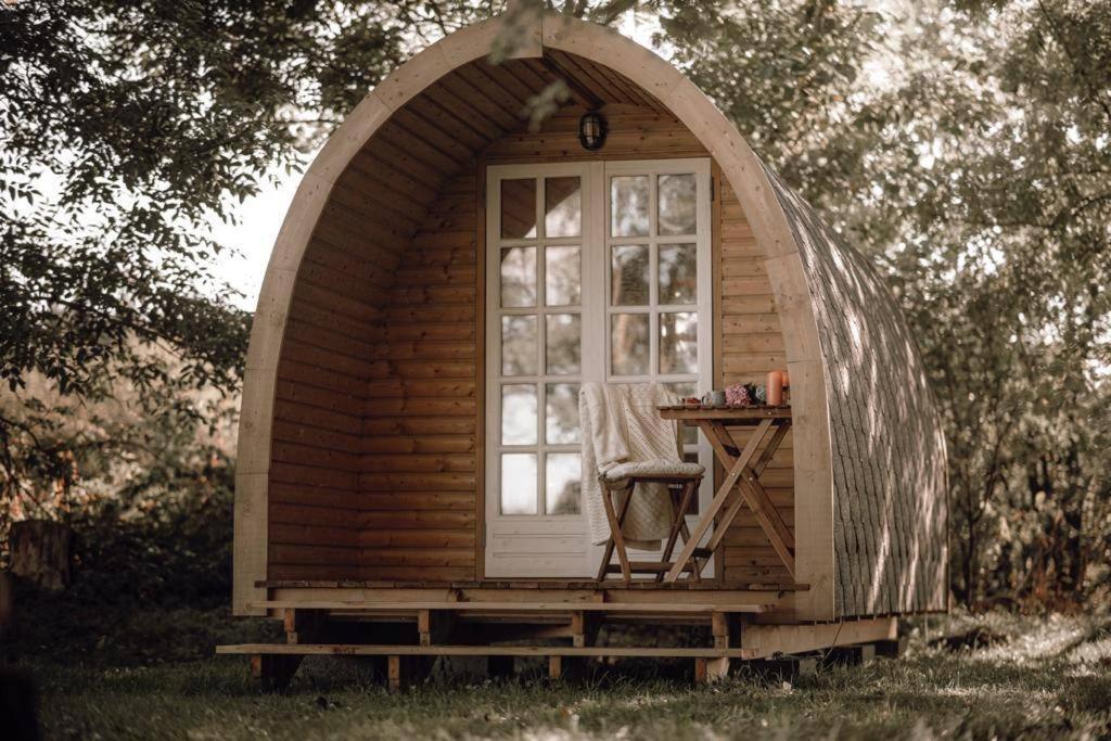 ein kleines Kuppelhaus mit einem Fenster im Gras in der Unterkunft Campingpod back to basic in Tønder