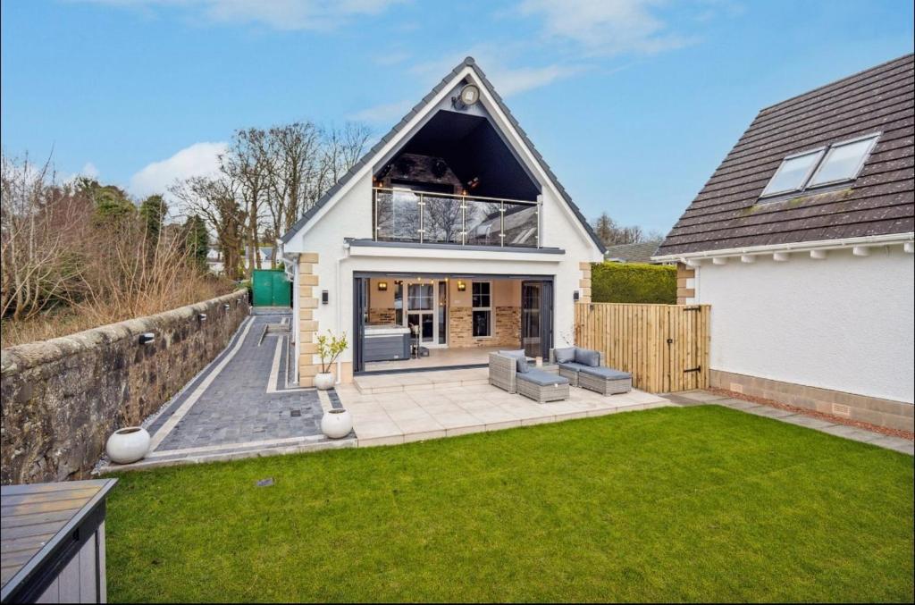 a house with a large window and a yard at Little Gleddoch in Dumbarton