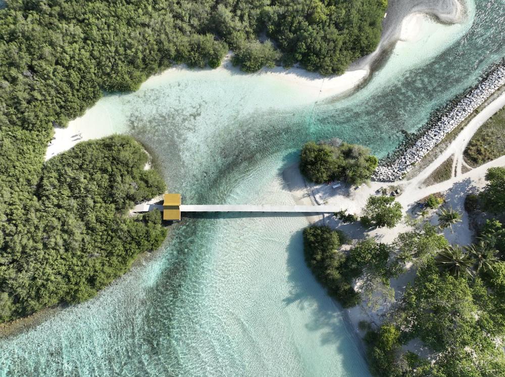 an aerial view of a bridge over a body of water at Surf Yoga Camp in Thulusdhoo