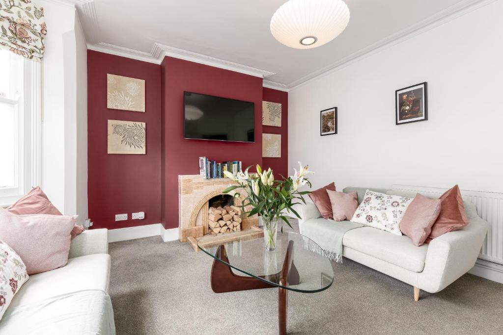 a living room with a couch and a fire place at Beautiful Edwardian Central Oxford home in Oxford