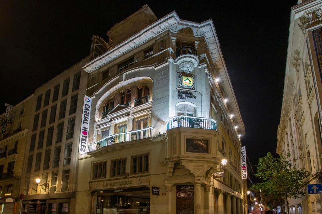 a building with a clock on the side of it at Casual del Teatro Madrid in Madrid