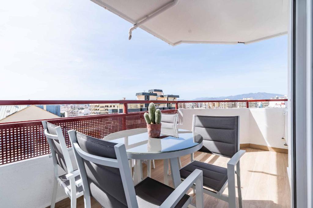 a table and chairs on a balcony with a view at Sur Suites Palmeras 9 in Fuengirola