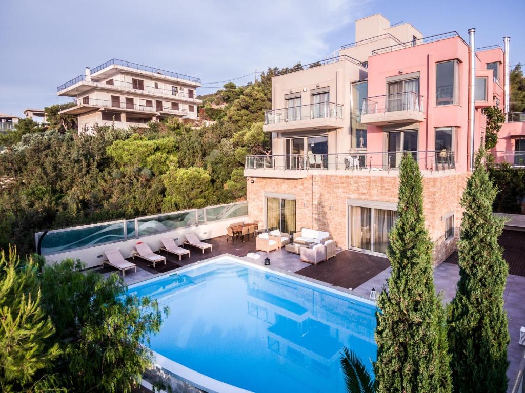 une image d'une maison avec une piscine dans l'établissement Deluxe Maisonette With Shared Pool 2#, à Anavyssos