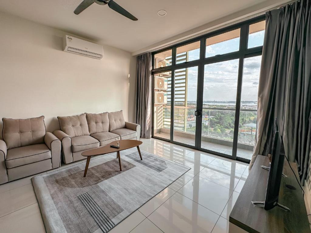 a living room with a couch and a table at [Starryhomes KIDS@ Green Haven]FREE Netflix +WI-FI in Masai