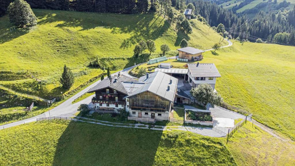 an aerial view of a large house on a hill at Ferienwohnung Hartlgut in Bad Hofgastein