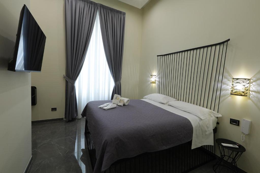 a bedroom with a bed and a large window at Il Salotto della Regina in Naples