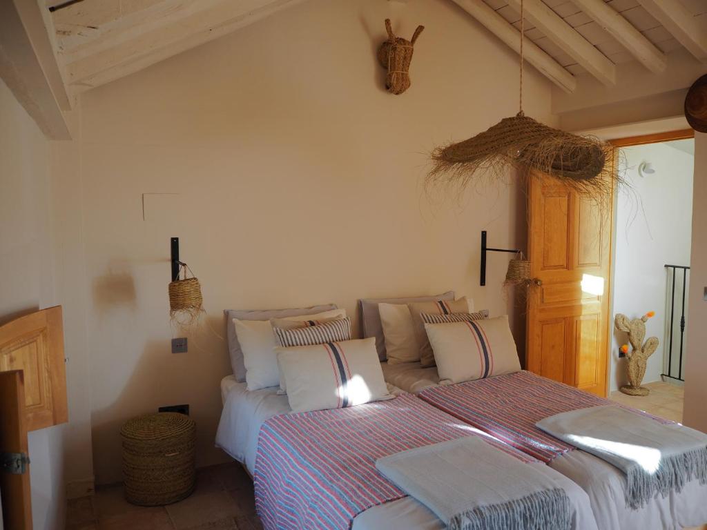 a bedroom with a bed with pillows on it at Casa Amandava in Salobreña