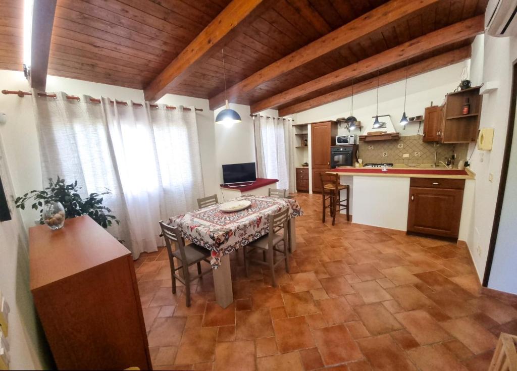 a kitchen and dining room with a table and chairs at Villa Sinforosa - Mondello in Mondello
