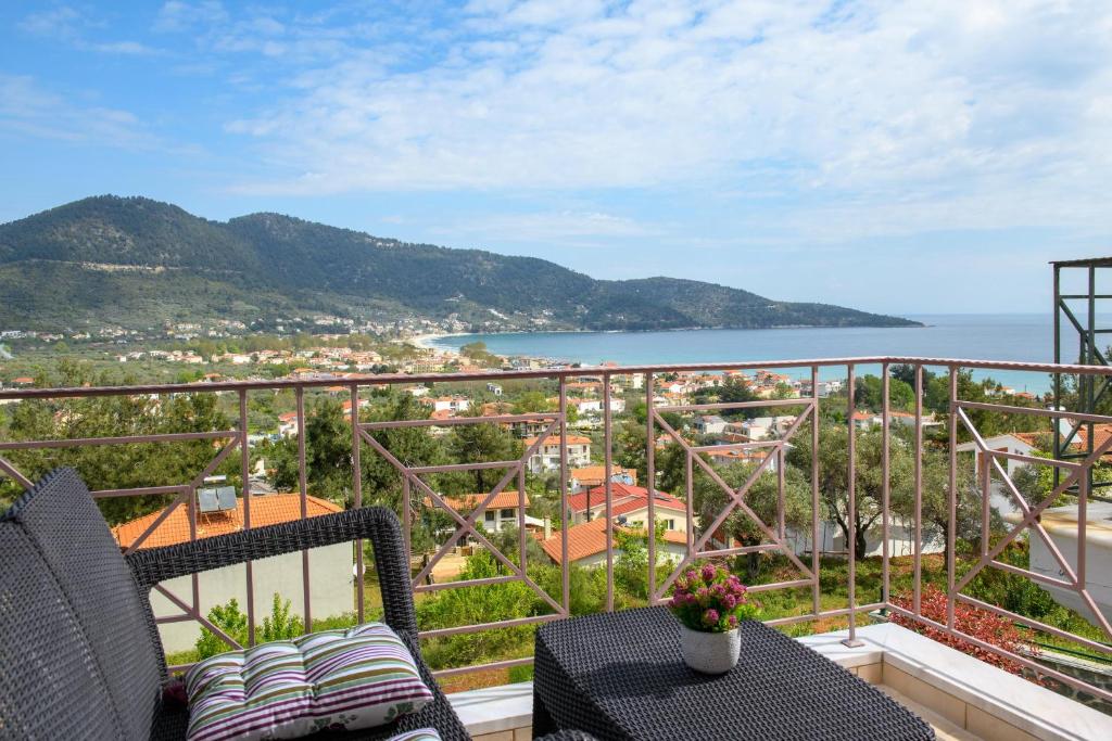 a balcony with chairs and a view of the ocean at Villa Panorama in Skala Potamias
