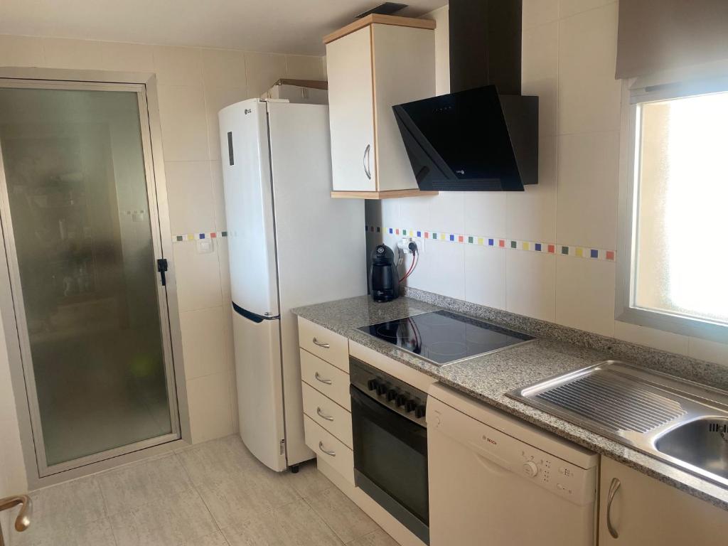 Kuchyň nebo kuchyňský kout v ubytování Apartamento Alcotan