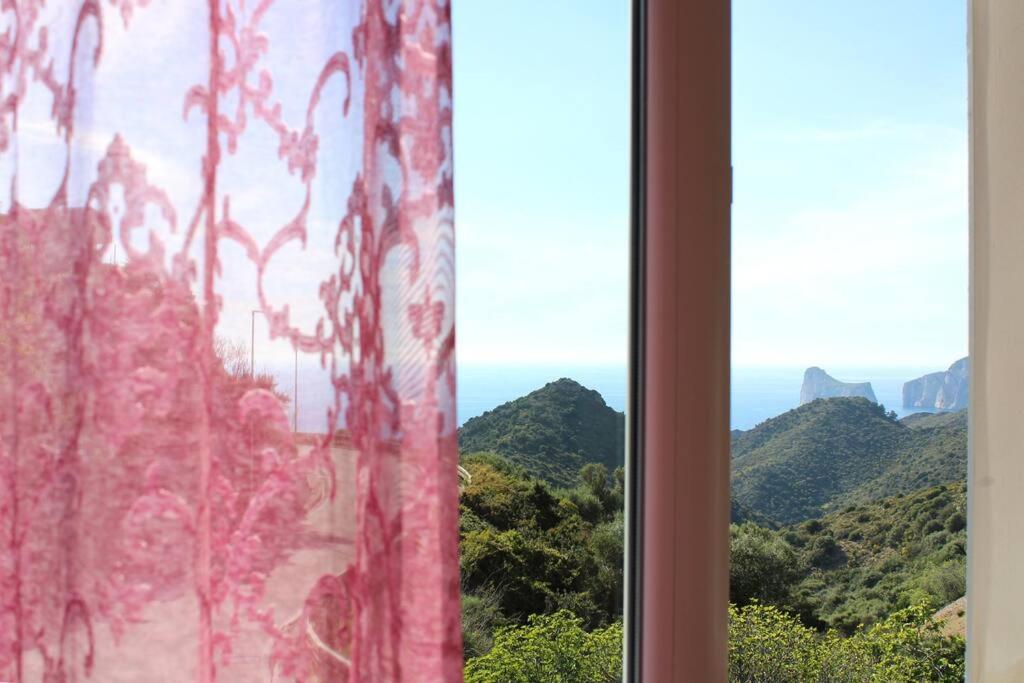 ein Fenster mit Bergblick in der Unterkunft Vida Noa - Casa vista mare - Sud Sardegna in Nebida