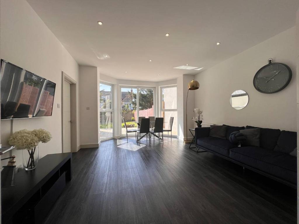 a living room with a couch and a table at Star London Finchley Road 3-Bed Oasis with Garden in London
